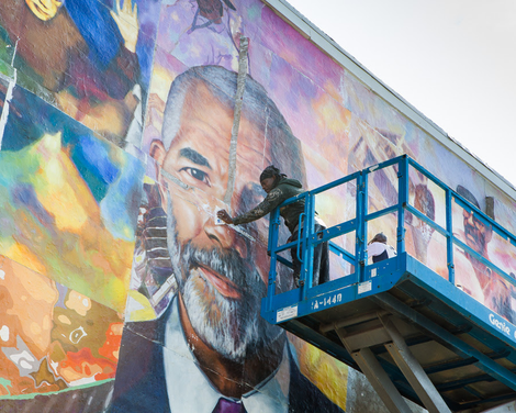 Ernel Martinez installing the Ed Bradley mural.